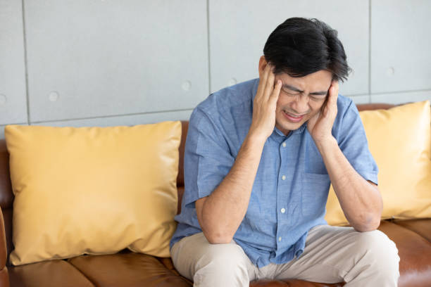 istock senior asian man suffering from headache at home 1297177267