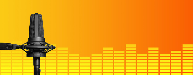 Professional studio microphone on orange and yellow background with vu meter and copy space. Broadcasting, podcasting or music recording banner
