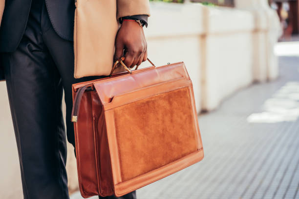 istock Business man holding a briefcase. 1297179599