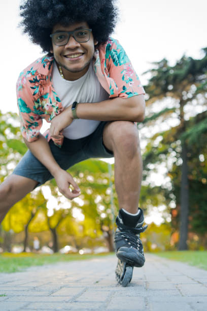 istock Latin man rollerskating on the street. 1297179600
