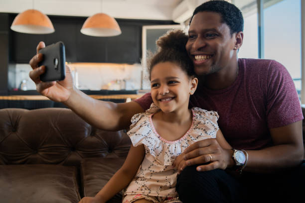 istock Daughter and father taking a selfie with phone. 1297179605