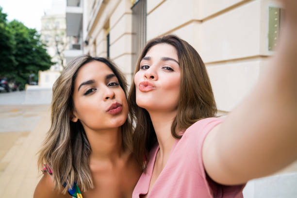 istock Two friends taking a selfie outdoors. 1297179704