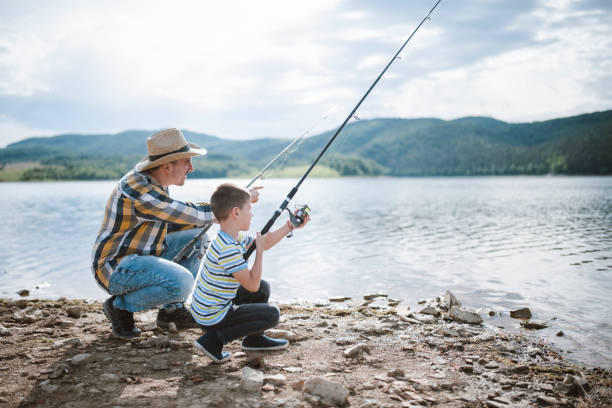istock Father teaching his son how to fishing. 1297179947
