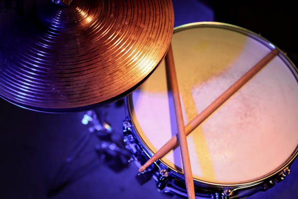 istock Drum sticks on a snare drum close up top view. 1297180325