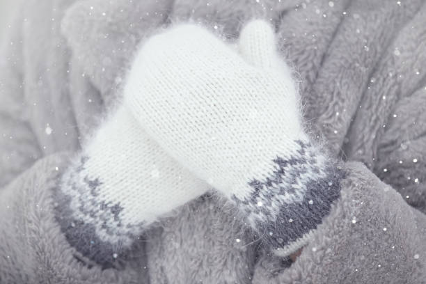 women's hands in hand-knitted down mittens with a pattern - glove winter wool touching imagens e fotografias de stock