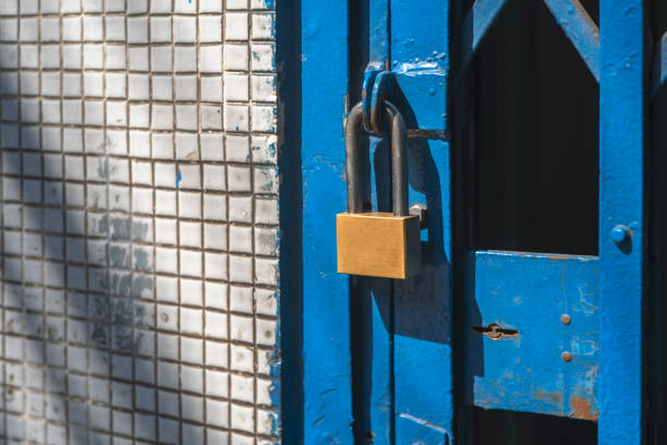 istock Close up old door locked with chain and padlock 1297180939