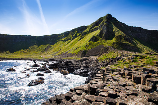 Landscape of Giant's Causeway trail with a blue sky in summer in Northern Ireland, County Antrim. UNESCO heritage. It is an area of basalt columns, the result of an ancient volcanic fissure eruption.