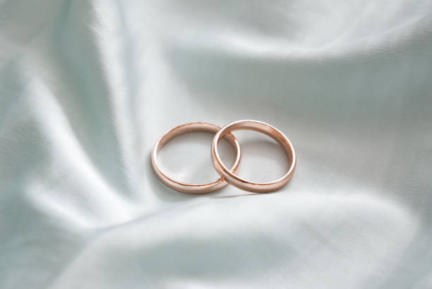 istock Wedding rings on a soft pastel background. 1297184747