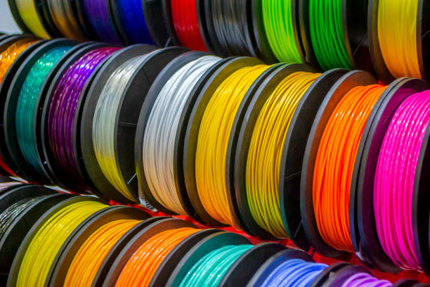 Multicolored filaments of plastic for printing on 3D printer close-up Multicolored filaments of plastic for printing on 3D printer close-up. Spools of 3D printing motley different colors thermoplastic filament. Motley ABS wire plastic for 3d printer. Additive technology light bulb filament photos stock pictures, royalty-free photos & images