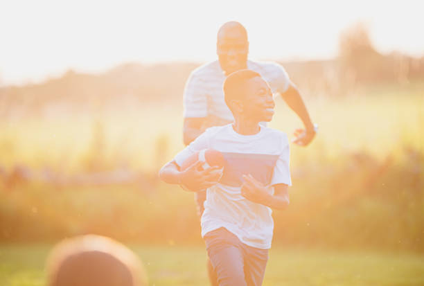 istock Father and son playing backyard football 1297186096