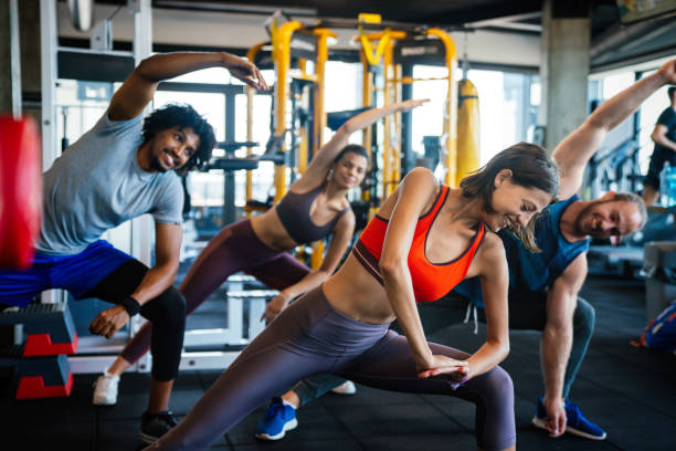 istock Group of young people doing exercises in gym 1297187576