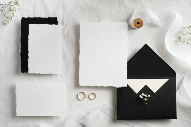 istock Wedding invites and envelopes on white background top view. Handmade wedding stationery set. 1297187789