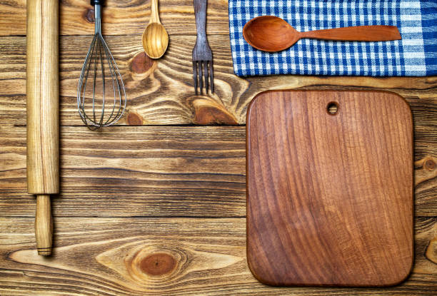istock Kitchen utensils (cooking tools) on a wooden background (top view, flat lay). Natural materials concept. 1297188159