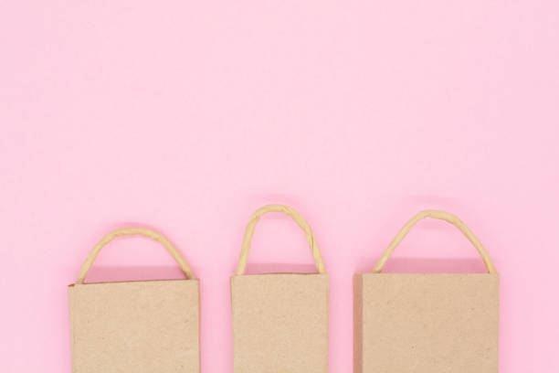 istock craft packages on a pink background. creative idea for shopping, sale 1297188516
