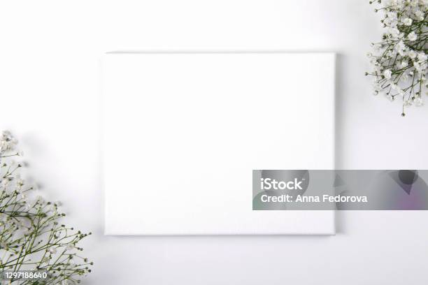 Canvas Mockup With Smal White Flowers On A White Background Stock Photo - Download Image Now
