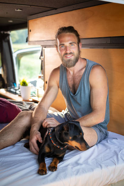 istock Man and his dog in a camper van 1297189804