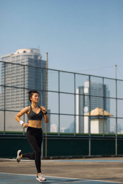 istock Cardio Workouts: Athletic Woman Running in a City 1297189842