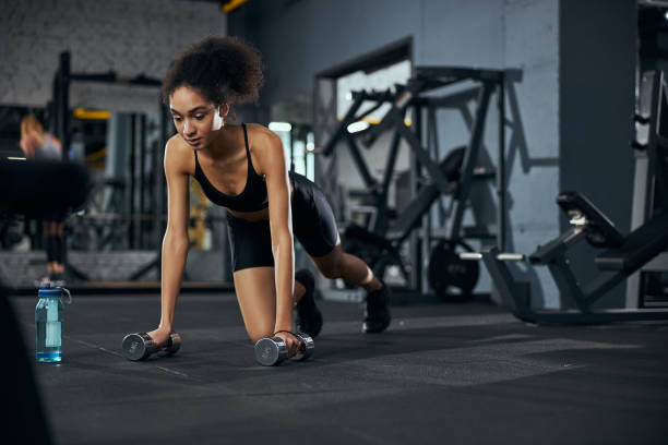 istock Young serious brunette woman doing physical training 1297190005