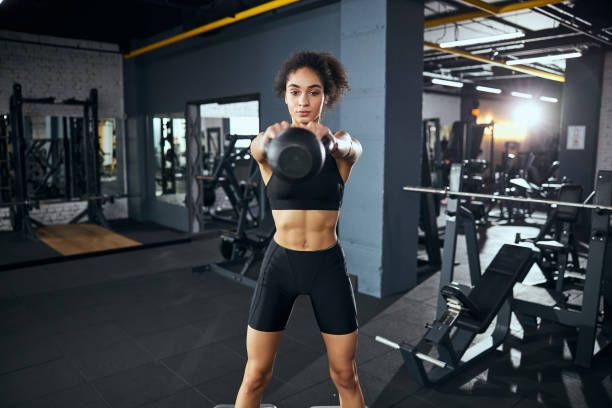 istock Competent sportswoman having workout at the gym 1297190158
