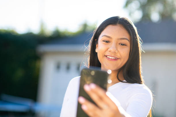 istock Young Woman Taking a Selfie in the Backyard 1297190273