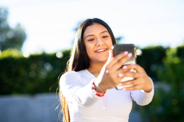 istock Young Woman Taking a Selfie in the Backyard 1297190295