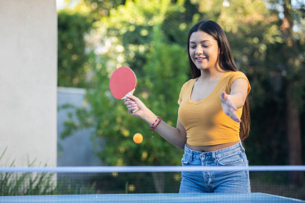 istock Young Woman Playing Ping Pong in the Backyard 1297190297
