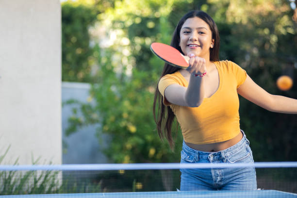 istock Young Woman Playing Ping Pong in the Backyard 1297190317