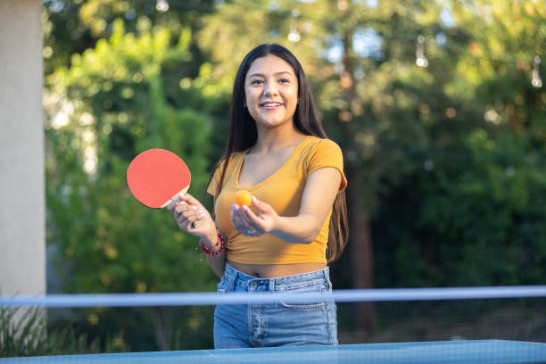 istock Young Woman Playing Ping Pong in the Backyard 1297190326