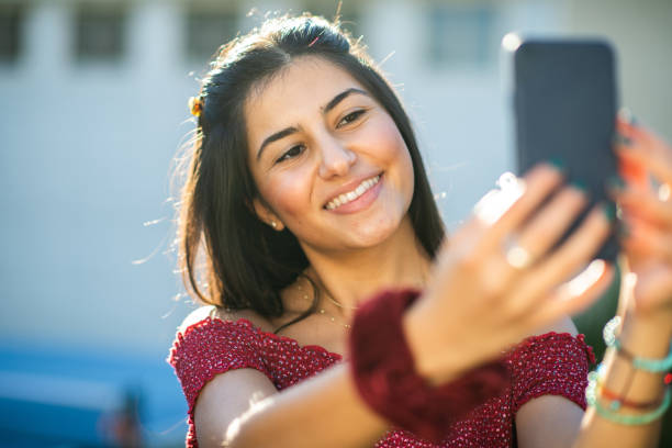 istock Young Woman Taking a Selfie Outside 1297190400