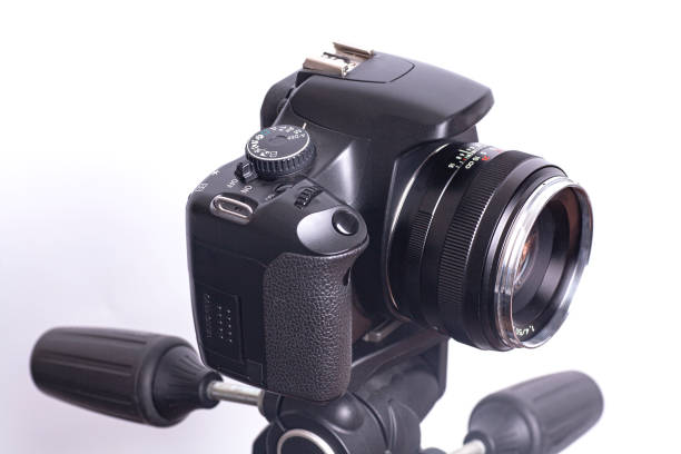 istock Digital photo camera on black tripod isolated on white background 1297190403