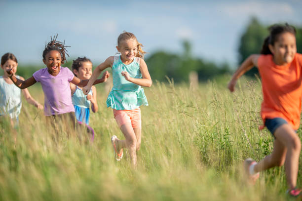 istock Kids running and laughing in a meadow 1297190677