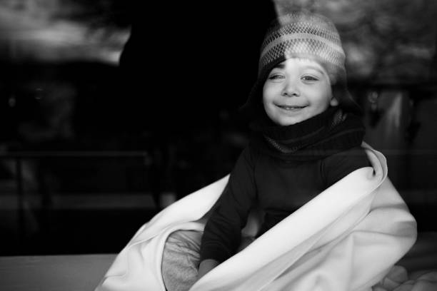 Happy boy day dreaming while looking through window. Shot with high megapixel DSLR camera, canon 5DSR