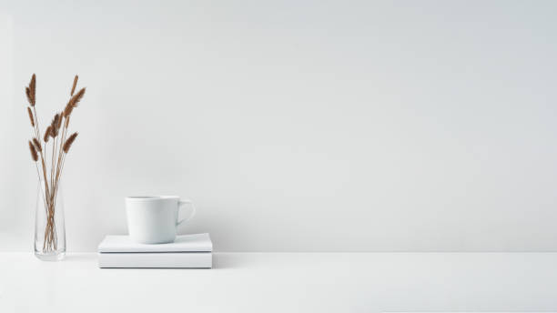 istock The mug stands on a stack of books on a white background. Natural and eco-friendly materials. Copy space, mock up. 1297191565