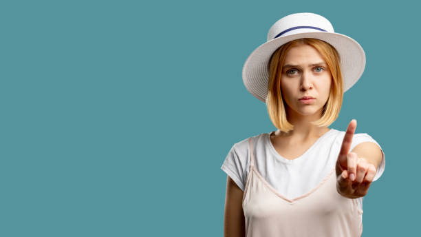 istock stop gesture keep silence worried woman finger 1297191631