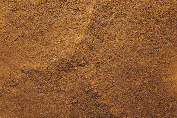istock dark yellow grunge cement wall, textured background. 1297192561