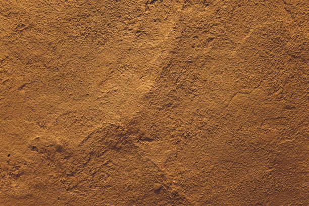 istock dark yellow grunge cement wall, textured background. 1297192568