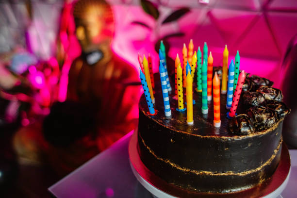 istock Birthday cake with candles, bright lights bokeh. 1297192819