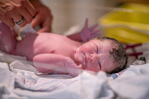 A newborn baby boy at the hospital's delivery room just minutes after he was born.