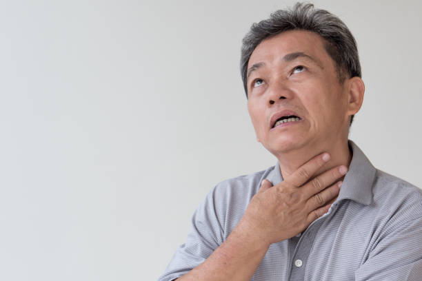 istock sick old man with sore throat, laryngitis, reflux 1297193427