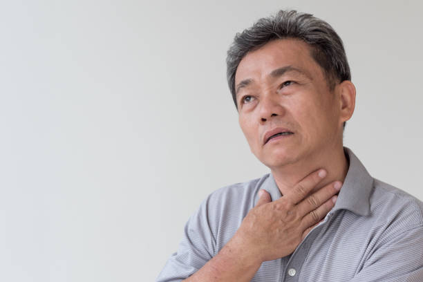 istock sick old man with sore throat, laryngitis, reflux 1297193435