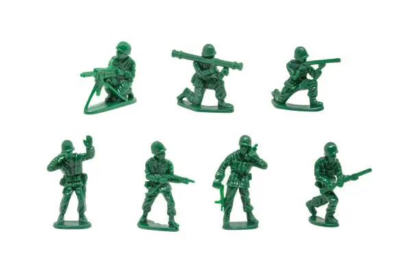 Photo of miniature toy soldiers with guns on white background