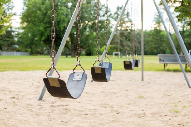istock Swings in the park playground 1297196750