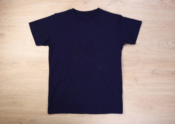 istock Front navy blue tshirt on wooden background 1297196887