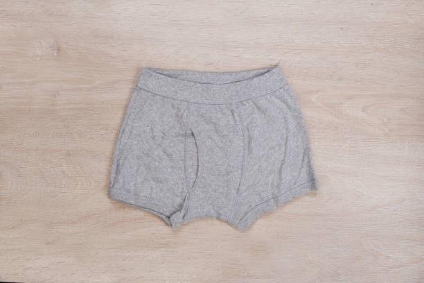 istock Font gray boxer short on wooden background 1297196906