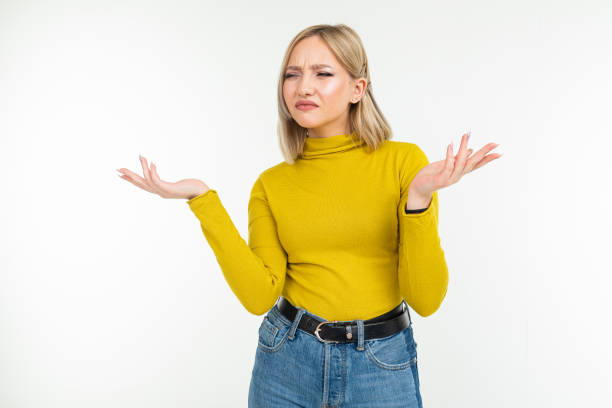 indignant blond girl in casual style waving her arms displeased on a white background with copy space - beauty teenage girls women in a row imagens e fotografias de stock