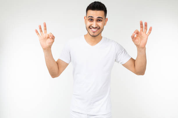 istock smiling guy in a white t-shirt with a mockup on a white background 1297199286