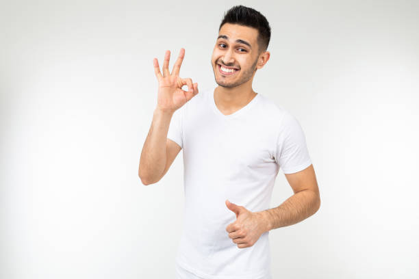 istock guy shows a mockup on his white t-shirt on a white background 1297199318