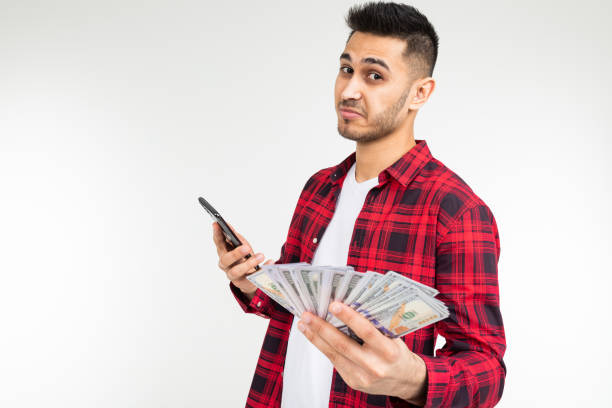 istock guy in a plaid shirt reports winning money by phone on a white background with copy space 1297199579