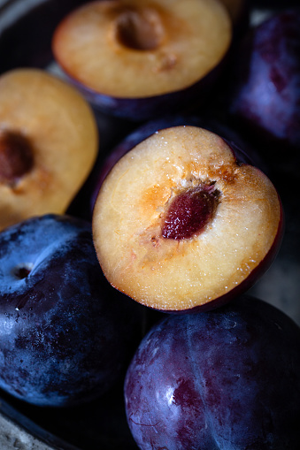 Purple plum slice. Close-up. Ripe, juicy plums.
