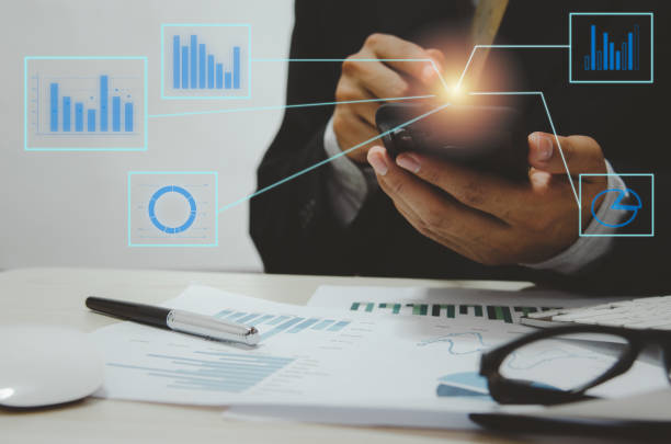 istock businessman hand phone digital graph and chart 1297200707